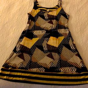 Reversible sundress stripes and on reverse side is a geometric pattern.